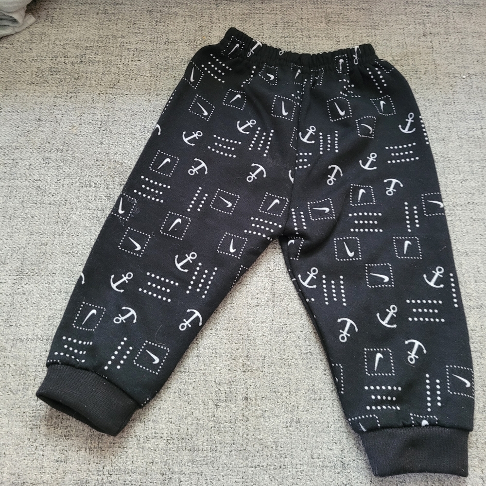 4/$20- back jogger styled pants. Featuring anchors and checks. Size 3-6M.